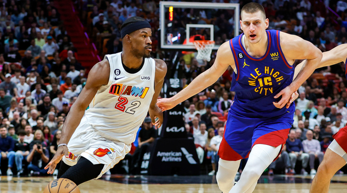 Heat’s Jimmy Butler dribbles past Nuggets’ Nikola Jokić.